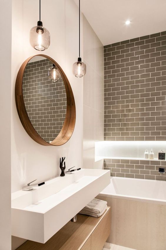 white single sink bathroom vanity with round mirror and pendant lights gray tile