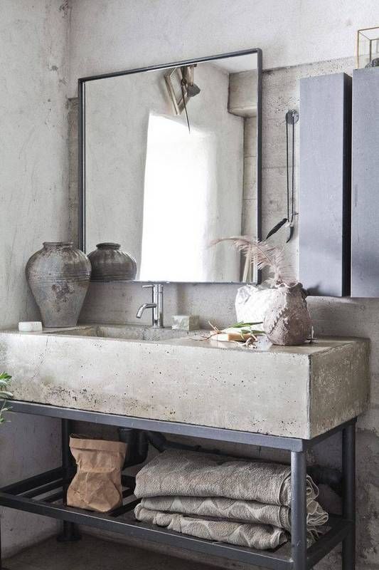 simple single sink modern bathroom vanity with concrete counter and black metal base