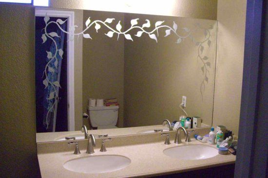 A custom etched bathroom vanity mirror