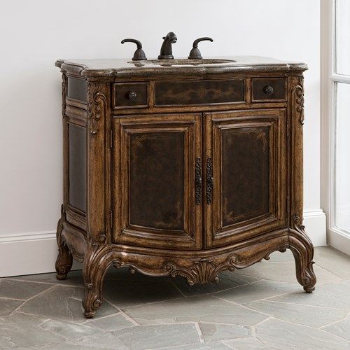 A beautiful mahogany recessed sink vanity with ornate engravings that will look stunning in any bathroom